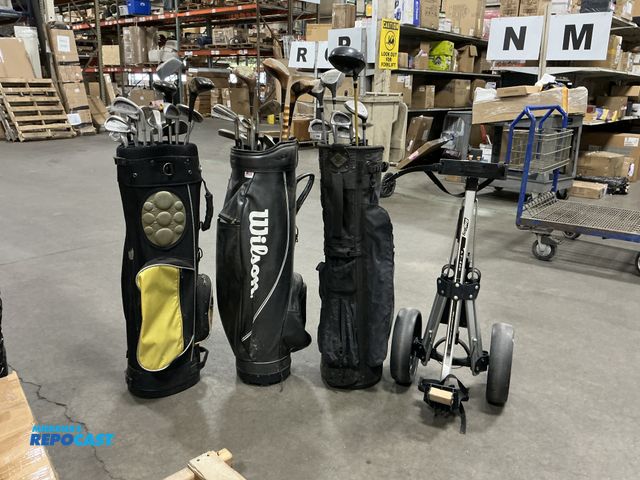 Lot 2-18830 - (3) golf bags with clubs &amp; The Bag Boy LT-400 lightweight, manual two-wheel golf push and pull c...
