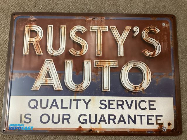 Lot 2-23833 - Metal Sign New Vintage looking metal sign. RUSTY’S AUTO Quality Service is our guarantee. Measures 1...