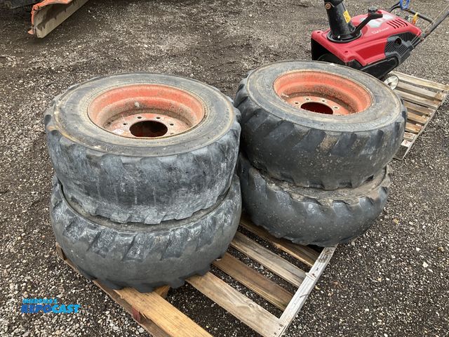 Lot 2-40555 - (4) 12-16.5 skid steer tires on steel 8-bolt wheels, used, tires are worn