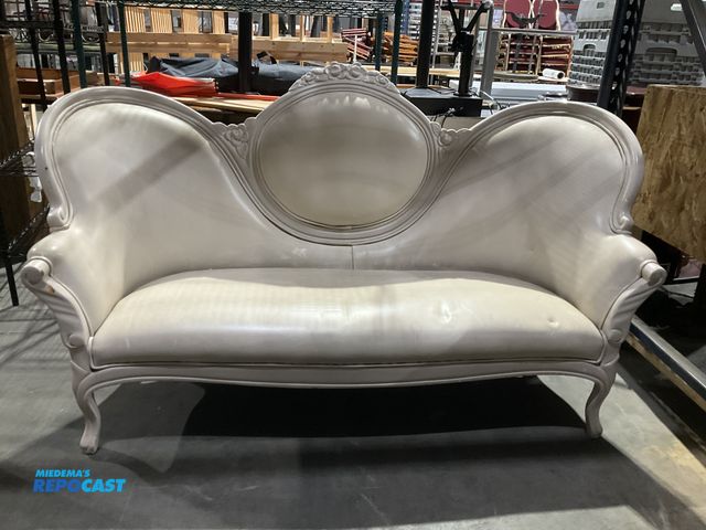 Lot 2-55027 - Cream Victorian Style Settee Cream colored Victorian style settee with ornate wood carving on back, ...