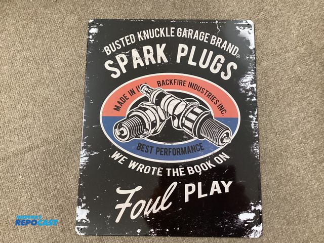 Lot 2-77716 - New vintage looking metal sign. Busted Knuckle Garage Brand Spark Plugs. We wrote the book on foul p...