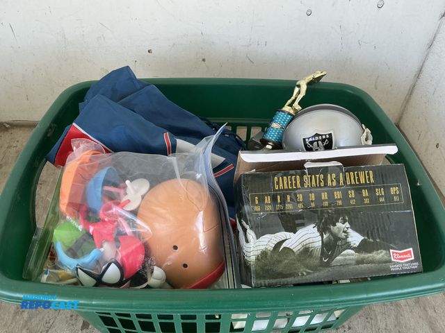 Lot 2-76314 - Lot of basket filled with misc. items including Potato toys, Raiders helmet, baseball trophies, bobb...