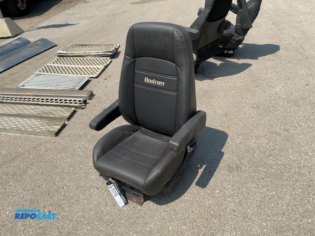 Lot 2-11119 - Used Bostrom Pro Ride Semi Truck Seat with Armrests, has air ride base