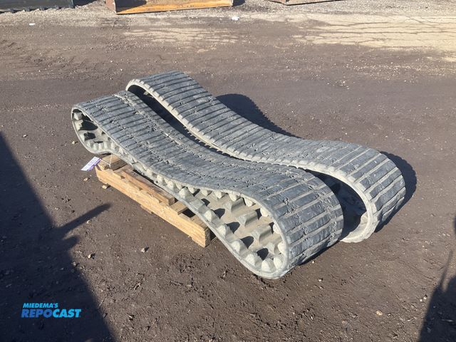Lot 2-33619 - Pair of 15” Caterpillar rubber tracks, p/n 325-8624, used, showing wear