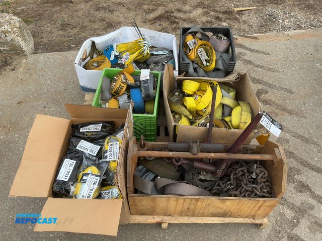 Lot 2-11505 - Skid of assorted e-track straps, includes box of new 12’ straps, also includes (3) chain binders