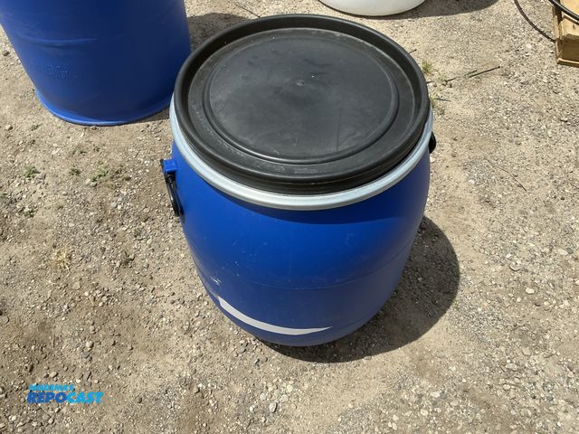 Lot 2-64037 - 25 gallon blue plastic barrel with removable lid and locking ring, contained a food product
