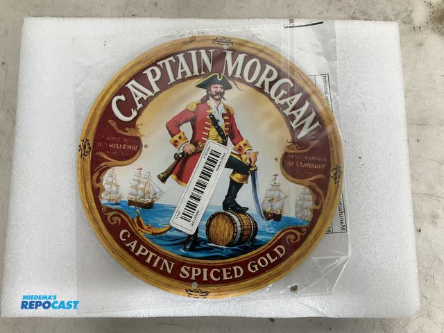 Lot 2-60961 - New 7.75” diameter Captain Morgan themed tin sign