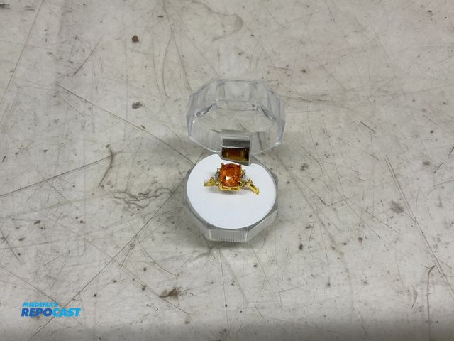 Lot 2-10052 - Yellow gold cubic ring with clear stones next to it size 12 case included