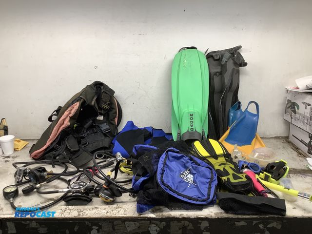 Lot 2-75990 - Lot of diving fins, goggles, a wetsuit, scuba diving pacs, oxygen guages, and more