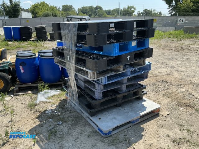 Lot 2-28660 - Stack of (11) blue, white, and black plastic stackable skids approx 43” x 43” x 5” and 56” x 44” x 5...