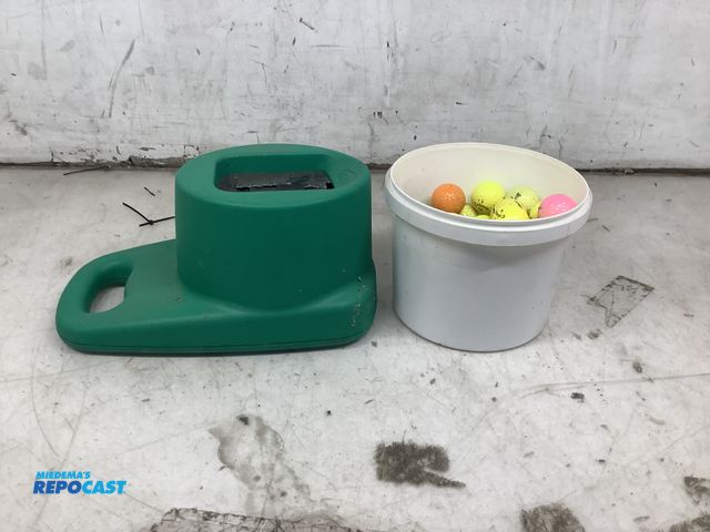 Lot 2-27722 - Bucket of golf balls and a golf club cleaner
