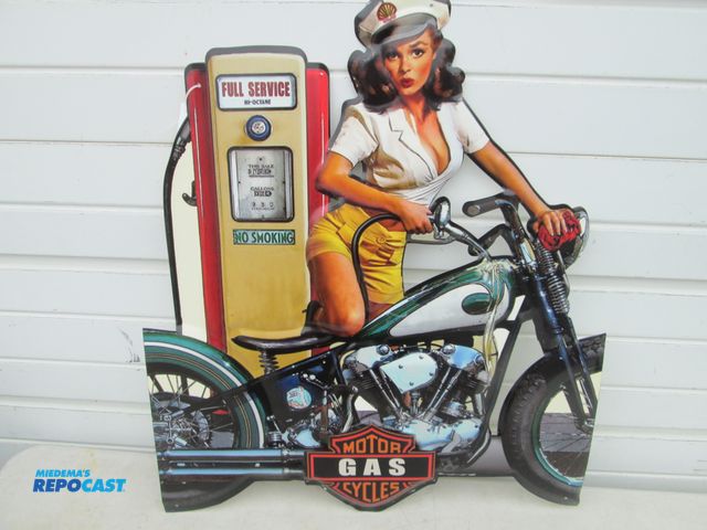 Lot 2-56921 - large die-cut embossed metal Harley Davidson motorcycle sign - woman spilling gas on bike - approx, ...