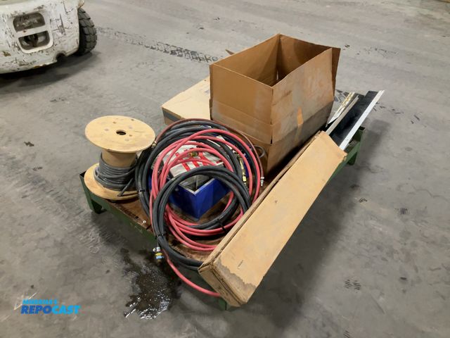 Lot 2-19396 - Skid lot of miscellaneous items including: wire, hoses, sweeper/broom attachments, etc.