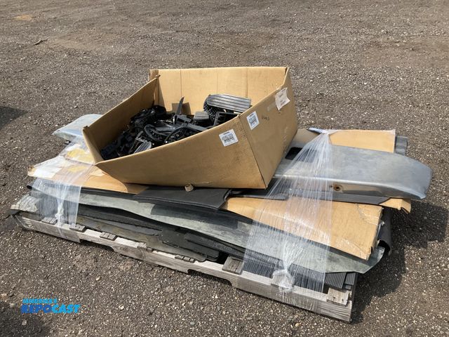 Lot 2-11083 - Skid of semi truck parts including a box of throttle pedals, front bumper, fairing and skirt rubber ...