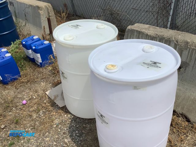 Lot 2-64404 - lot of 2 55 gallon white plastic barrels with 2 removable bungs, contained mineral oil