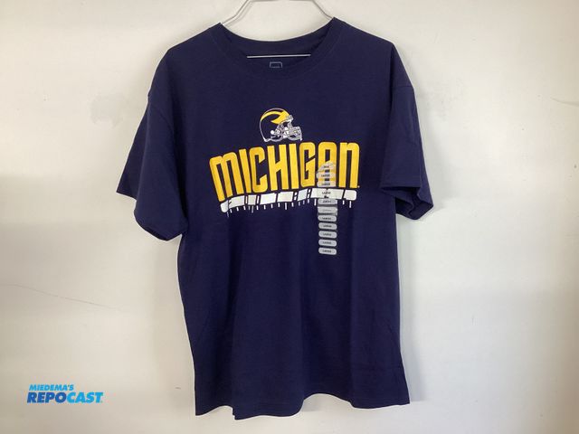 Lot 2-19207 - New University of Michigan Football t-shirt by Pro Edge. Maize and Bluetooth. Men’s size Large.