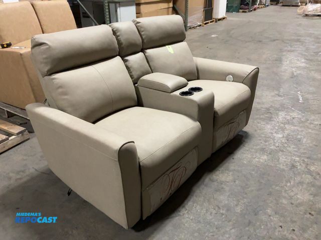 Lot 2-15532 - New Sofa Grayish tan 2 cushion sofa, foot stool/recliner, with divider and cup holders, 62” x 34” x ...