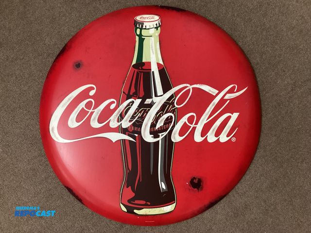Lot 2-77644 - New round metal sign. Coca-Cola by Open Road. Measures 24” across.