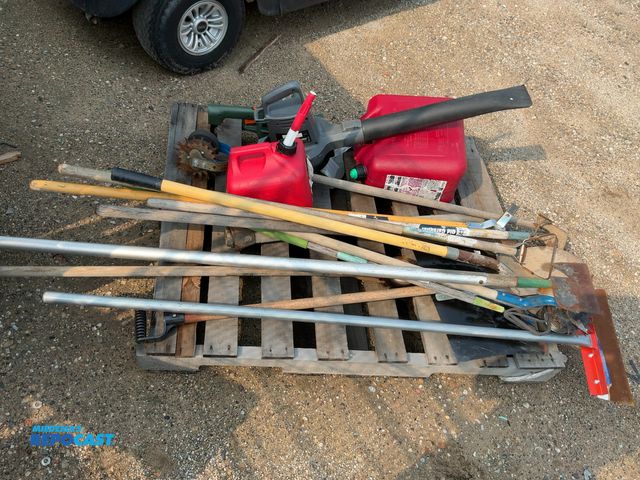 Lot 2-11161 - Skid lot of miscellaneous lawn items including shovels, scrapers, rakes, blowers, gas cans, and more