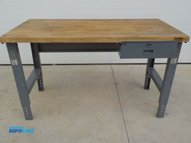 Lot 2-34102 - Industrial Global wood top work station. One drawer. Adjustable legs. 60 in l . 30 in d. 36 in h.