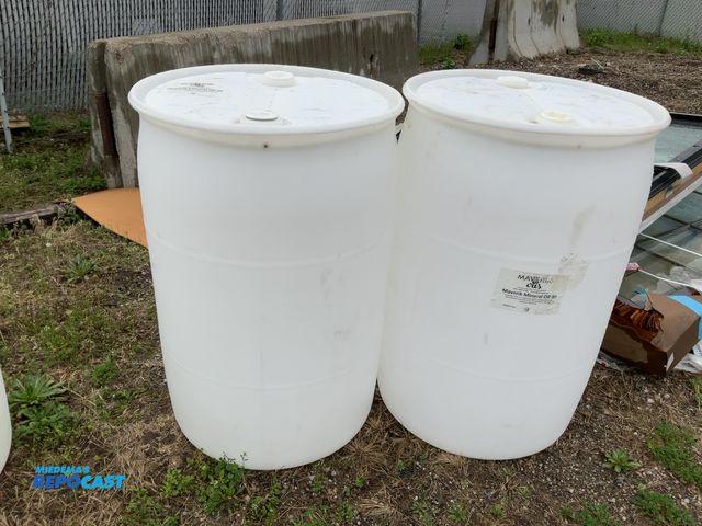 Lot 2-94818 - lot of 2 55 gallon white plastic barrels with 2 removable bungs, contained mineral oil