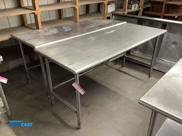 Lot 2-23882 - (2) Stainless Steel tables, 72” long by 30” wide by 34” tall. One table is missing a foot for the le...