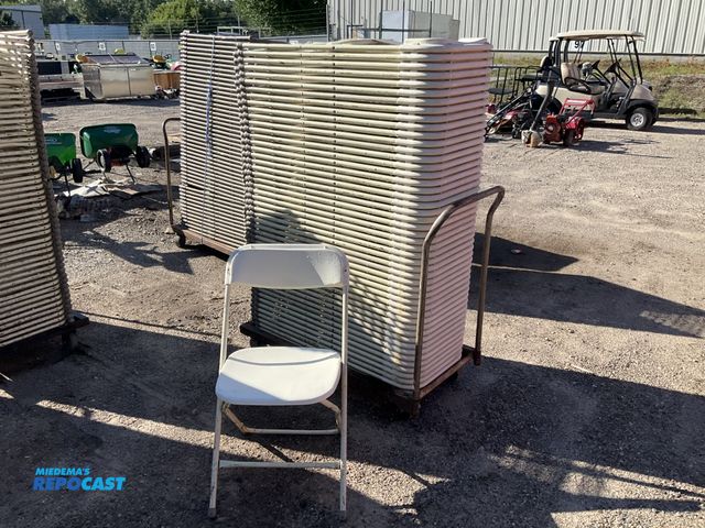 Lot 2-13925 - Chairs Stack of plastic and metal foldable chairs white on a metal rolling cart