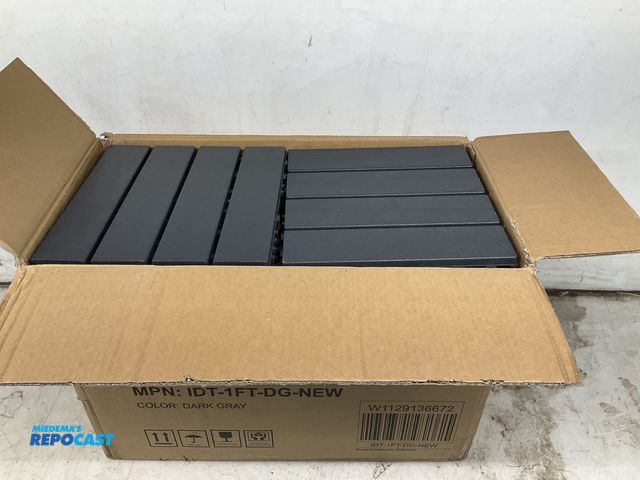Lot 2-60949 - New box of (44) item number IDT-1FT-DG-NEW,  approx. 25” x 12.5” x 18” dark gray interlocking deck t...