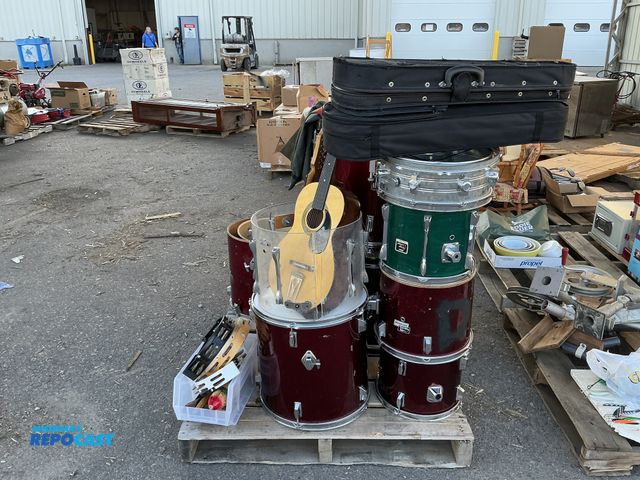 Lot 2-99719 - Skid Lot of drums &amp; electric guitar, acoustic guitar, Vietnam army uniforms, tambourines, and mo...
