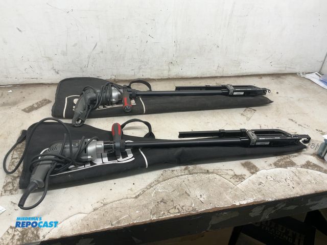 Lot 2-69709 - Lot of 2 senco electric screw drivers with auto feed attachments, both come with a senco storage bag