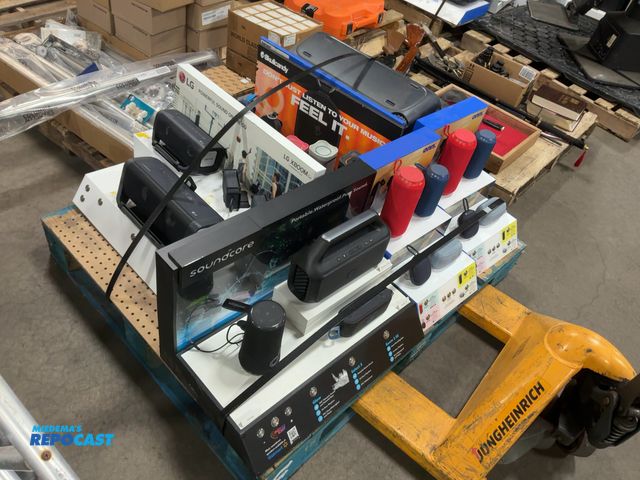 Lot 2-23802 - Skid lot of many speakers/displays including brands such as soundcore, skullcandy, LG, and onn
