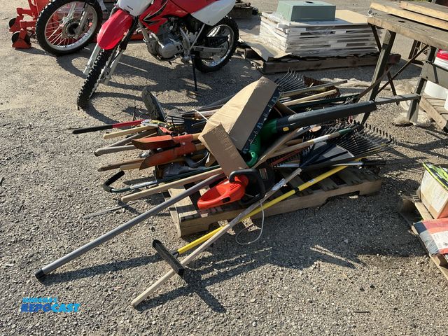 Lot 2-99068 - Skid lot of various lawn and garden items including brooms, rakes, blowers, and more