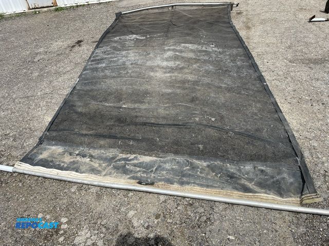 Lot 2-72738 - Used manual debris tarp, 86'' wide x 13 1/2' long , some minor holes in top.