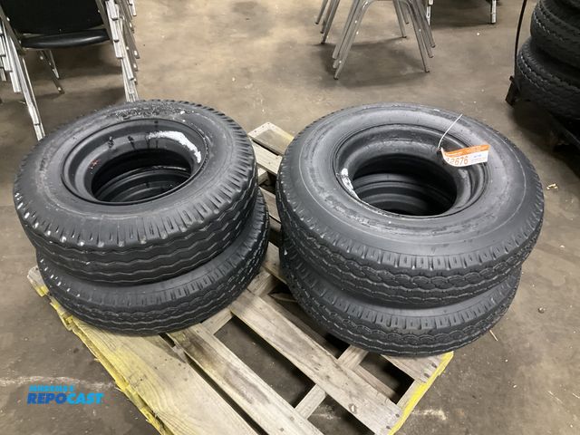 Lot 2-42676 - (4) 8-14.5 tires on steel mobile home style wheels, used, one tire is flat and off the bead