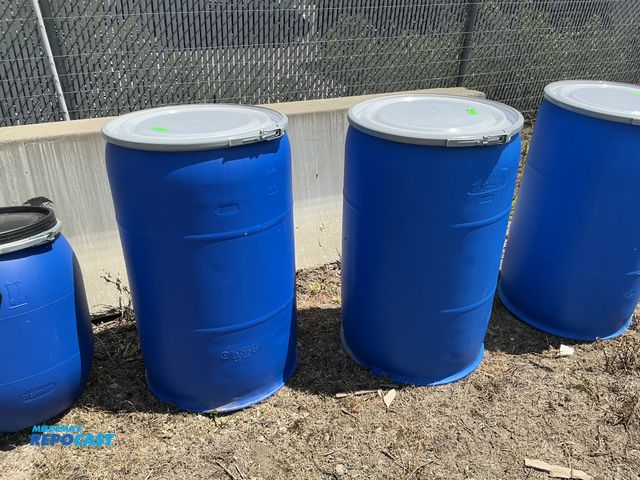 Lot 2-76869 - 2 55 gallon blue plastic barrels with removable lids and locking rings, contained a food product
