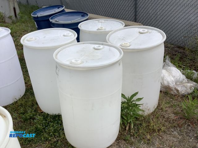 Lot 2-15589 - lot of 4 55 gallon white plastic barrels with 2 removable bungs, contained mineral oil