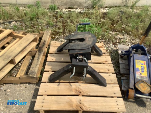 Lot 2-64394 - Single handle locking mechanism with a hitch ear legs and a mounting bracket.