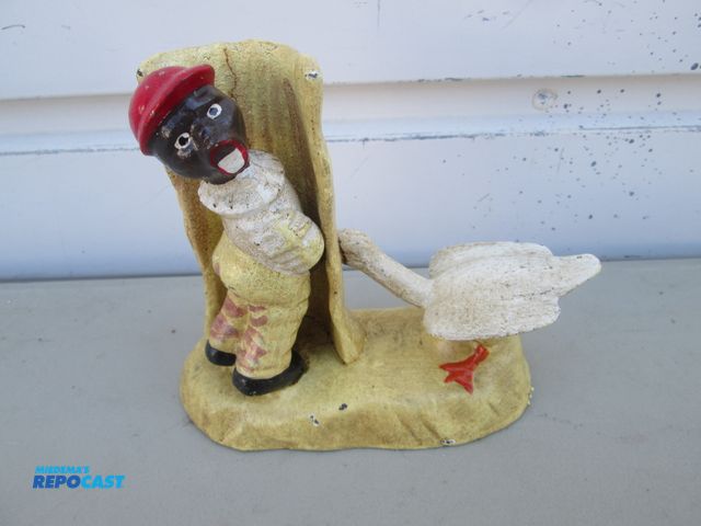 Lot 2-56967 - Cast iron Figure of young man urinating through a fence w/ a goose on the other side of the fence - ...