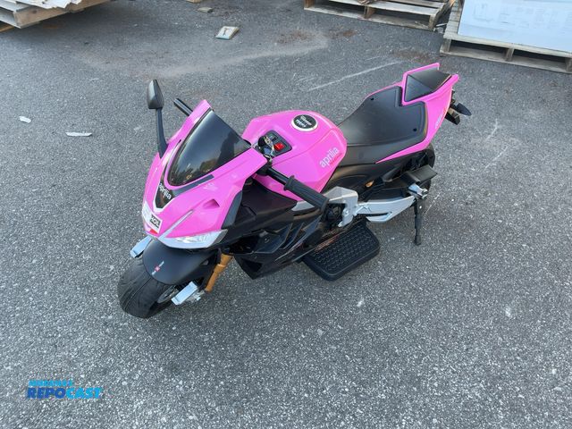 Lot 2-96739 - Aprilia RSV4 kids ride on motorcycle. Missing throttle grip.
