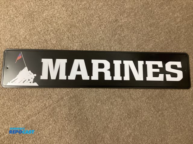 Lot 2-92861 - New metal sign. Marines.  Measures 24” X 5” and has holes in each end for hanging.