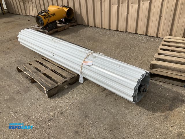 Lot 2-42331 - Trac-Rite 9’W x 7’T metal roll up door with, tack, spring and mounting brackets, unused, has some de...