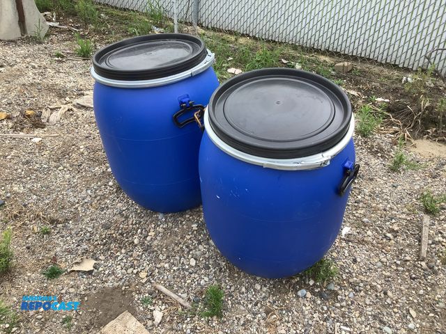 Lot 2-99963 - (2) 25gal. blue plastic barrels w/ removable lids and locking rings - clean inside, contained a food...