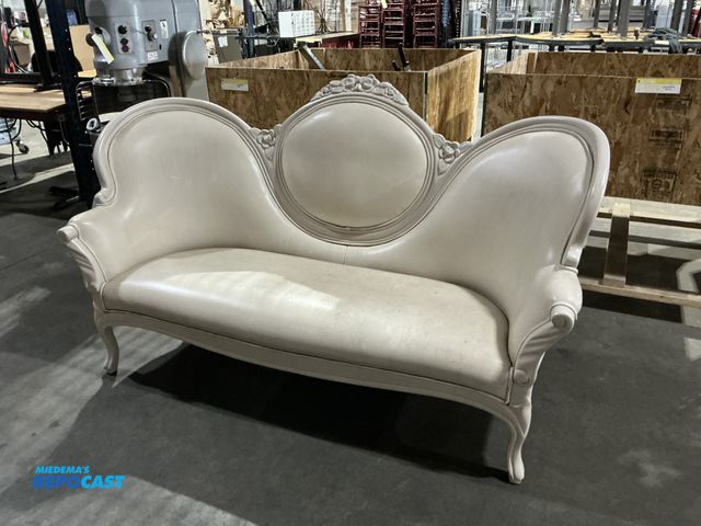Lot 2-55173 - (1) Cream colored Victorian style settee with ornate wood carving on back, arms, and legs, has some ...