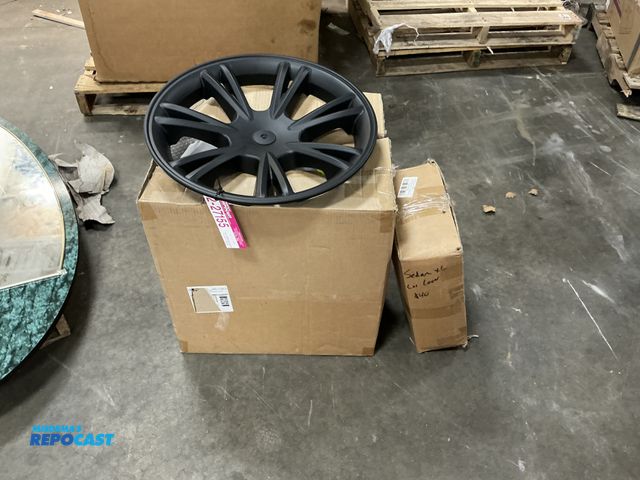 Lot 2-27155 - car cover with a box of black hub caps