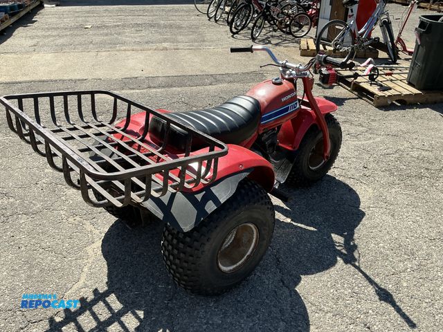 Lot 2-76741 - Red Honda 110 3-wheeler all terrain cycle with metal basket on back gas powered
