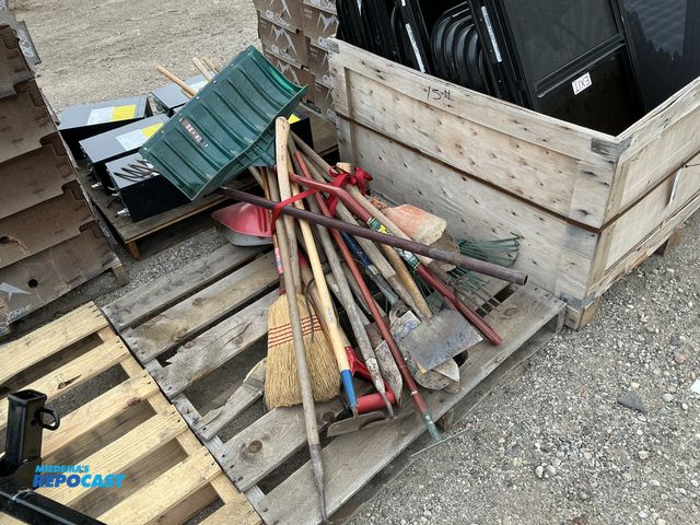 Lot 2-62942 - Lot of antique farm tools, including hoes, rakes, pitchforks, and brooms.