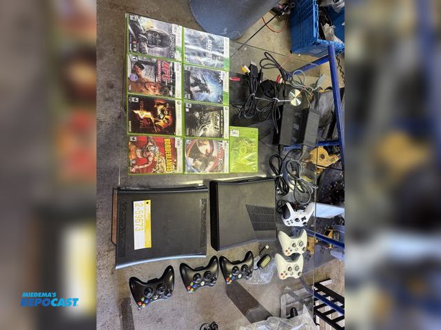 Lot 2-59673 - Set of two Xbox 360 game consoles with games controls, and cables tested works