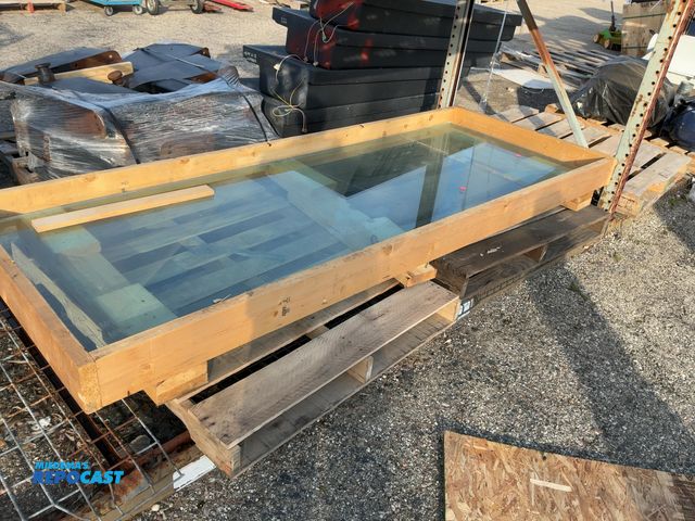 Lot 2-65666 - Wood board box with large bulletproof glass with crack peice approximately 95” long and 33” wide