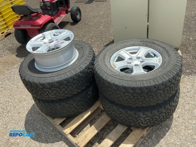 Lot 2-22665 - (5) 17” Jeep Alloy Wheels, 5-lug, four have BFGoodrich Size 285/70R17 Tires Mounted on Them, one cen...