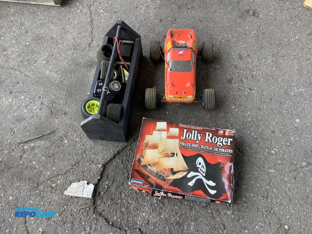 Lot 2-27206 - Remote controlled RC car with replacement tires and Jolly Roger 1/30 pirate ship model kit #70874